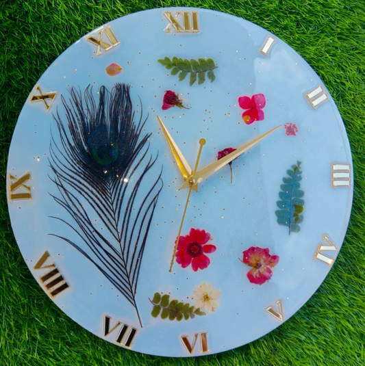 This stunning Resin Wall Clock features real preserved flowers encased in clear resin, creating a unique and beautiful piece of functional art. Each clock is handcra